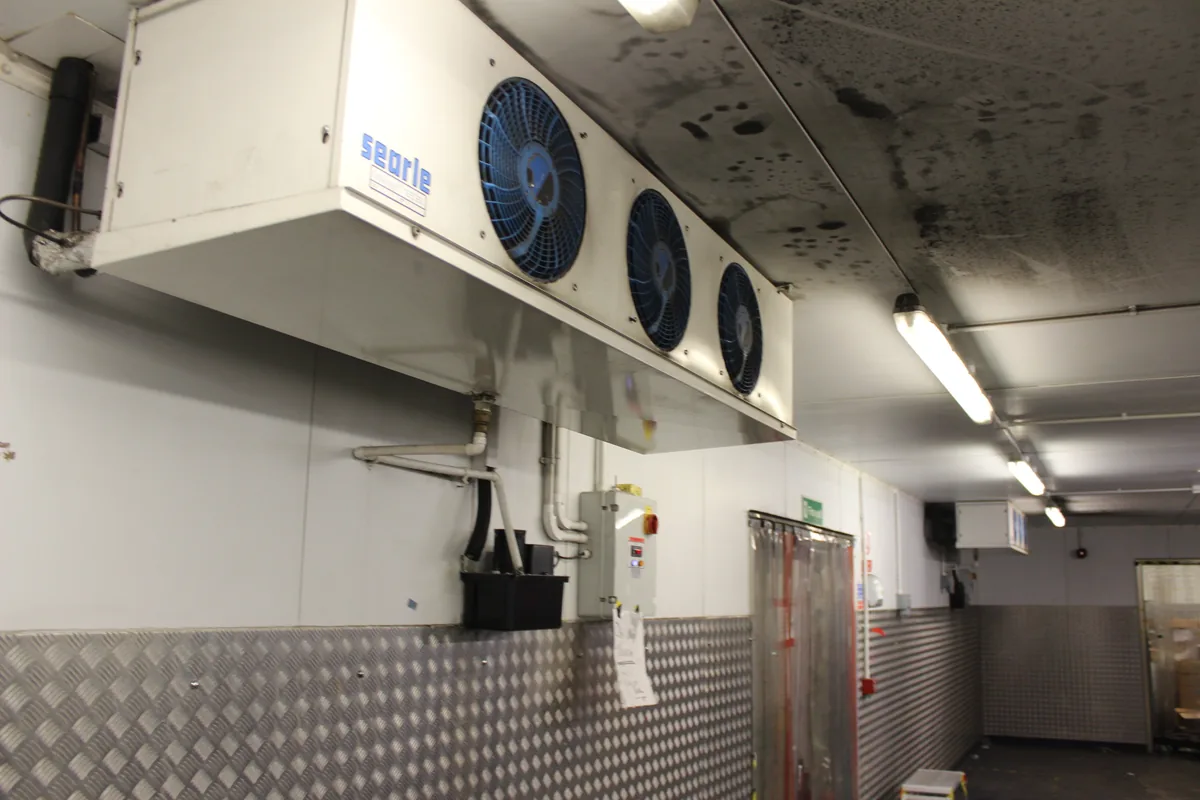 A chiller evaporator and the ceiling around it soiled before the clean
