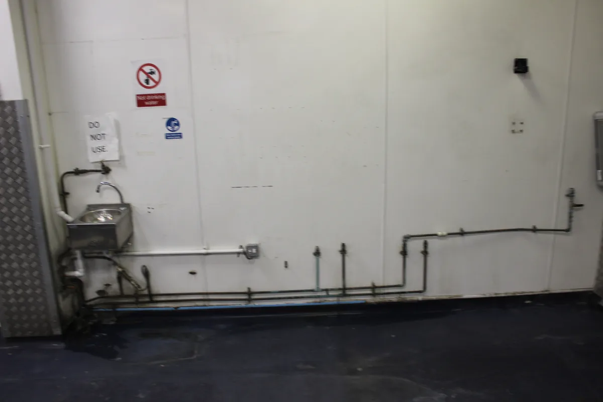 The same wall and pipework clean after the clean
